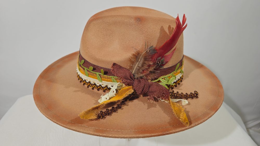 Ember Sage — tan wide-brim hat with botanical trim and feather accents