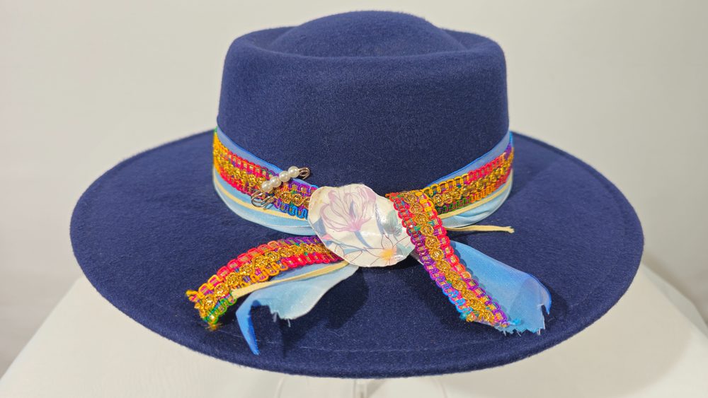 Midnight Caravan — navy wide-brim hat with jewel-toned braided trim and feathers