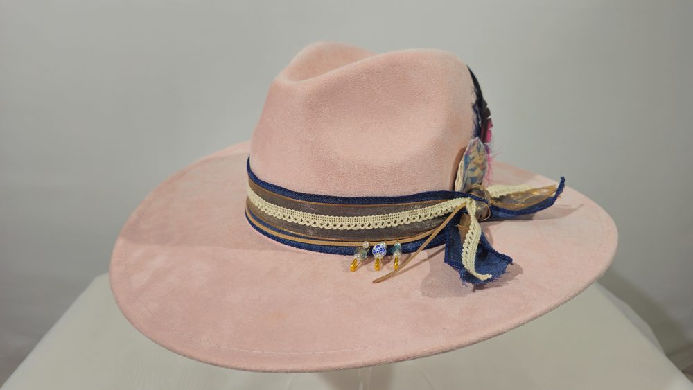 Rose Oracle — blush pink wide-brim hat with lace, ribbon, and feather detailing